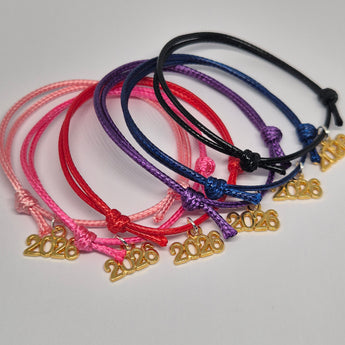 Class of 2026 friendship bracelets party bag fillers UK Colourful bracelets with gold tone 2026 charms on a white background