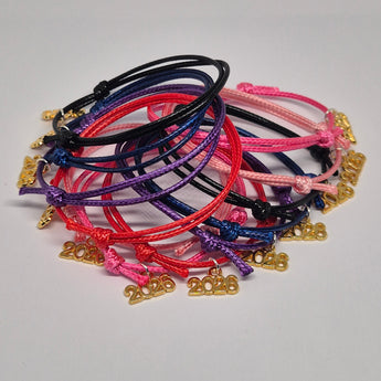 Set of colourful bracelets with gold tone 2026 charms on a white background