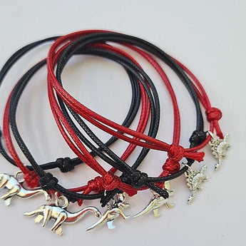 6 red and black dinosaur charm bracelets party bag filler