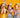Three children with party hats blowing confetti