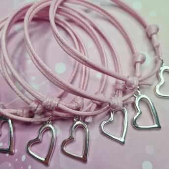 Pink friendship bracelets with heart charm for party bag filler and gifts