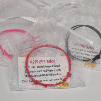 Class of 2026 friendship bracelets with wish note in a organza bag against a white background